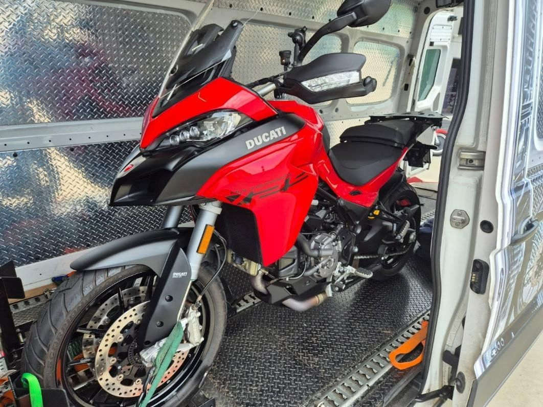 A Red Ducati Motorcycle Is Parked In The Back Of A Van — Motow Motorcycle Transport In Sandgate, NSW