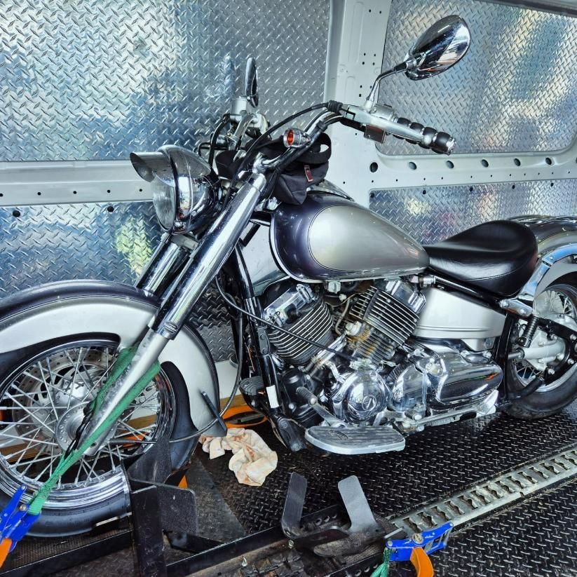 A Motorcycle Is Tied To The Side Of A Van — Motow Motorcycle Transport In Sandgate, NSW