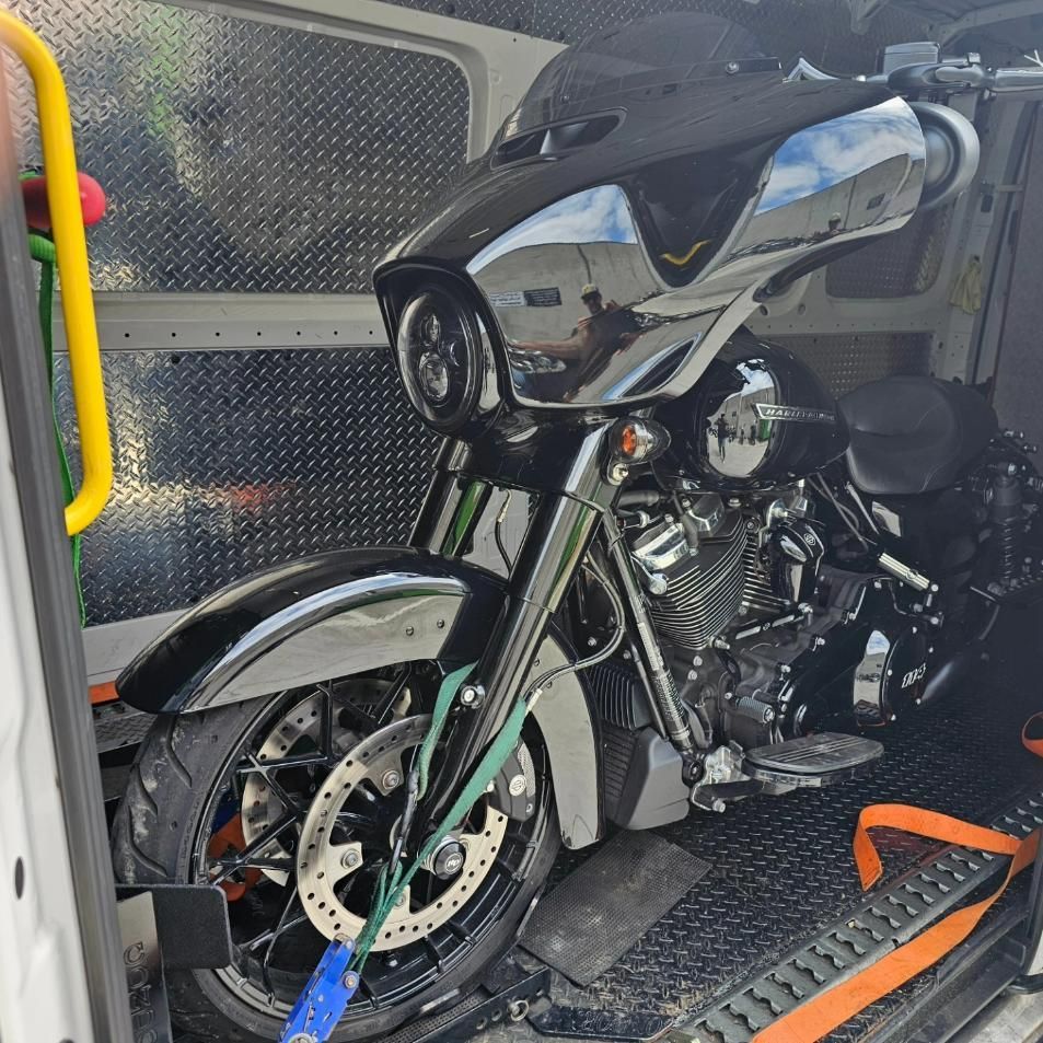 A Black Motorcycle Is Sitting In The Back Of A Van — Motow Motorcycle Transport In Sydney, NSW