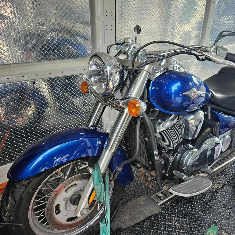 A Blue Motorcycle Is Parked In A Van — Motow Motorcycle Transport In Newcastle, NSW