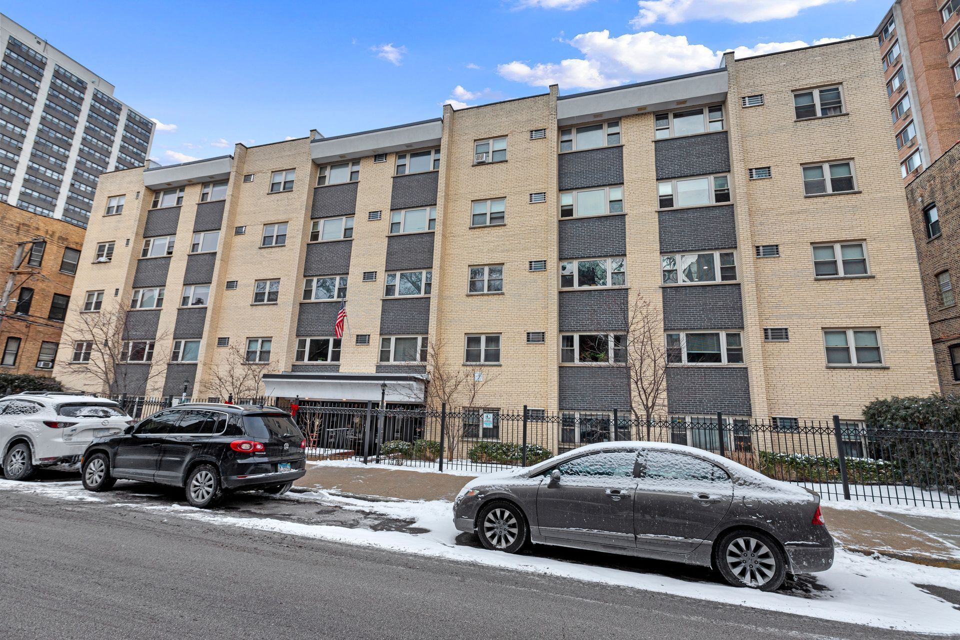 A large building with cars parked in front of it