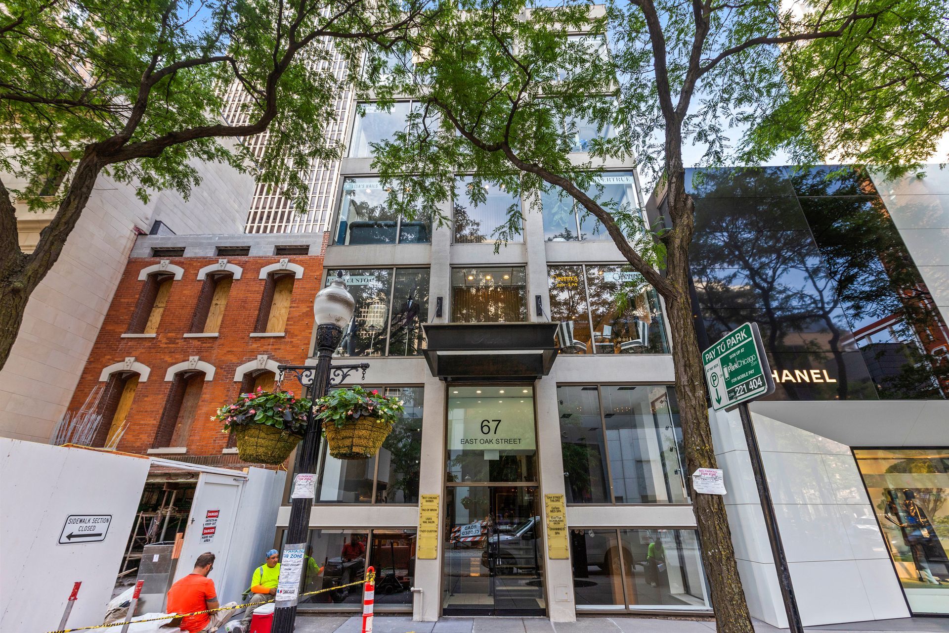 A large building with a lot of windows and trees in front of it.