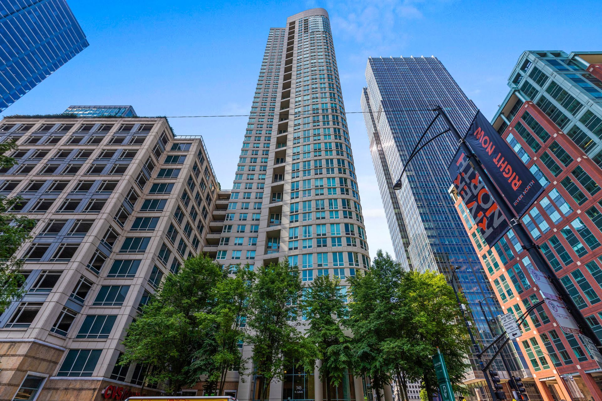 Looking up at a row of tall buildings in a city.