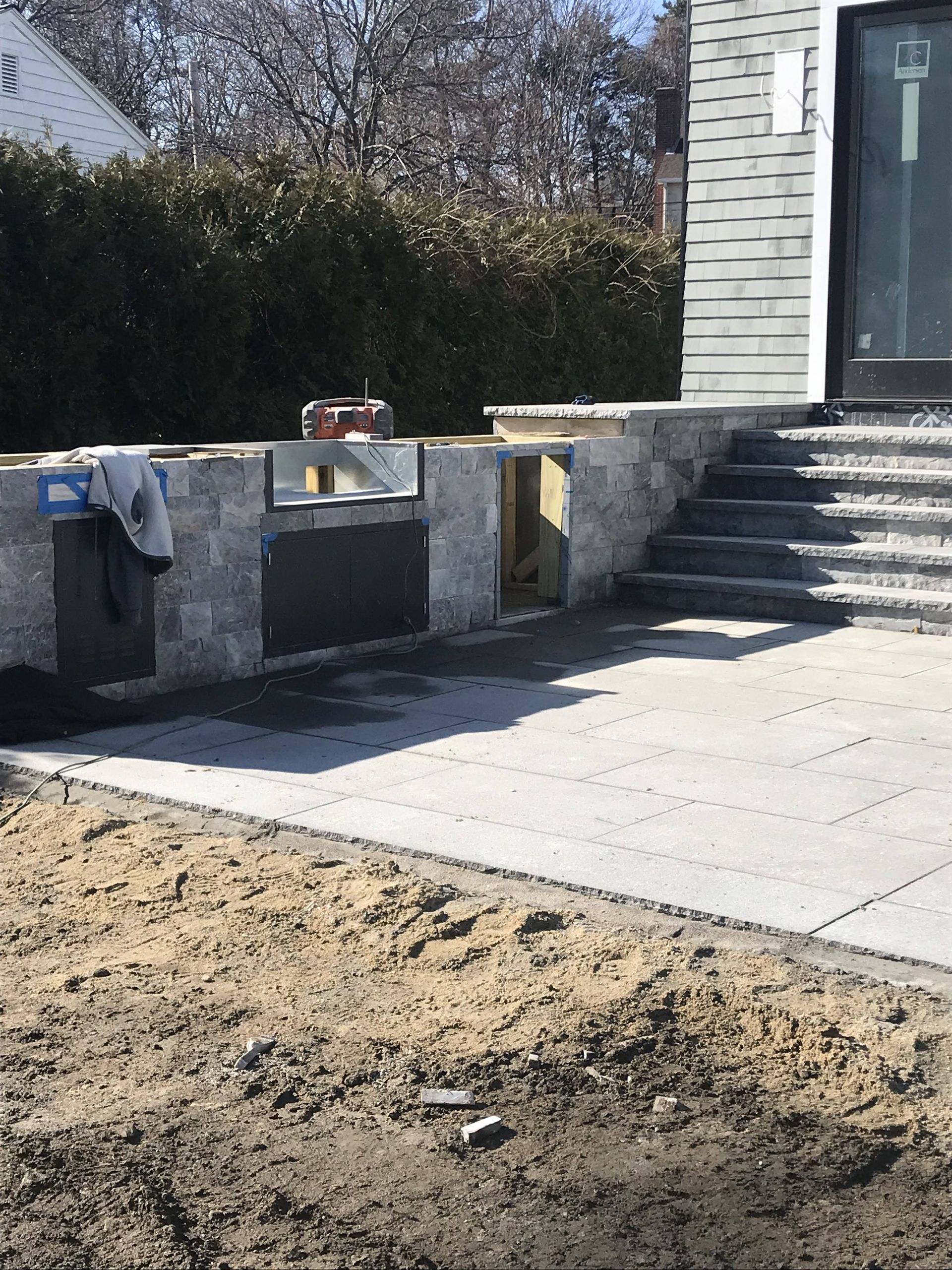 A patio is being built in front of a house