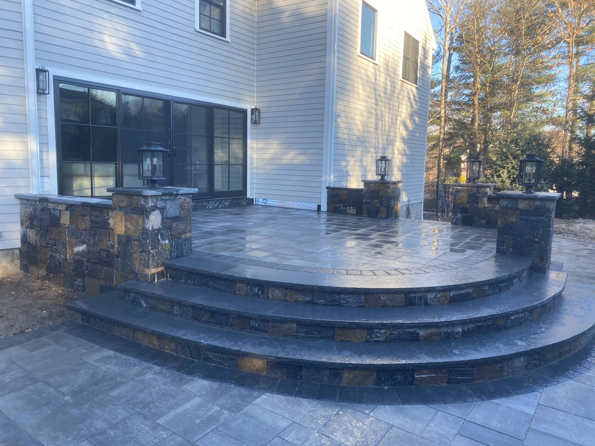 A patio with steps leading up to a house.
