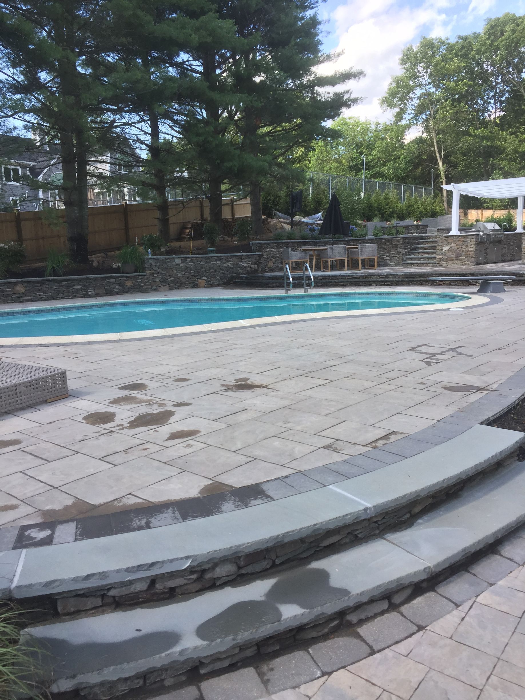 A large swimming pool with stairs leading to it