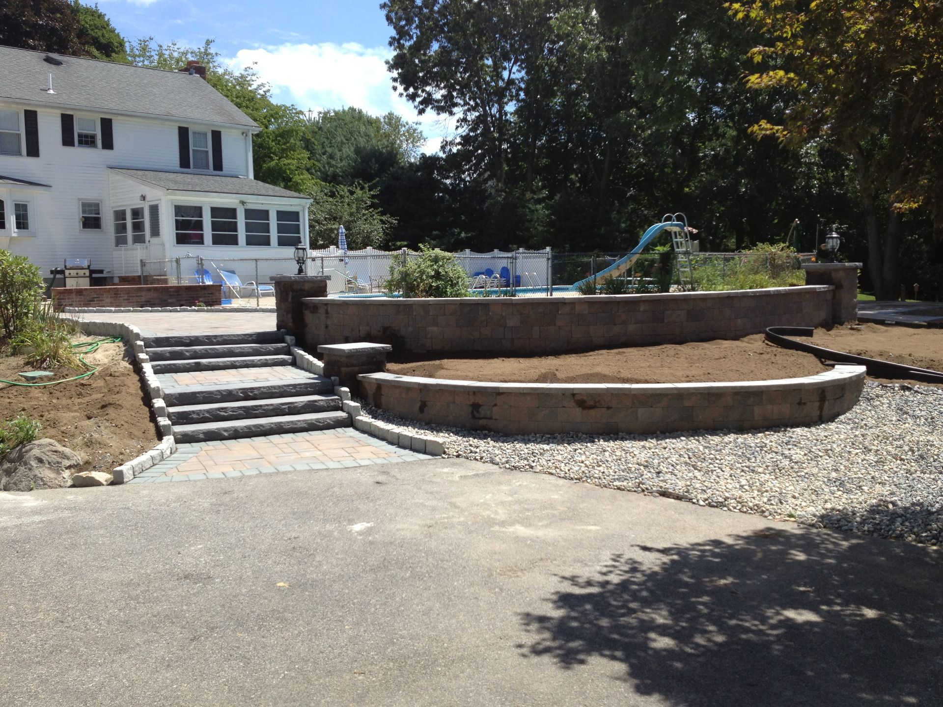 A large white house with a swimming pool in the backyard