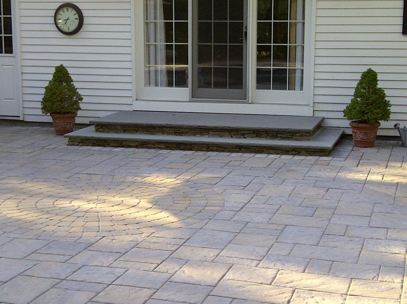 A white house with a clock on the side of it