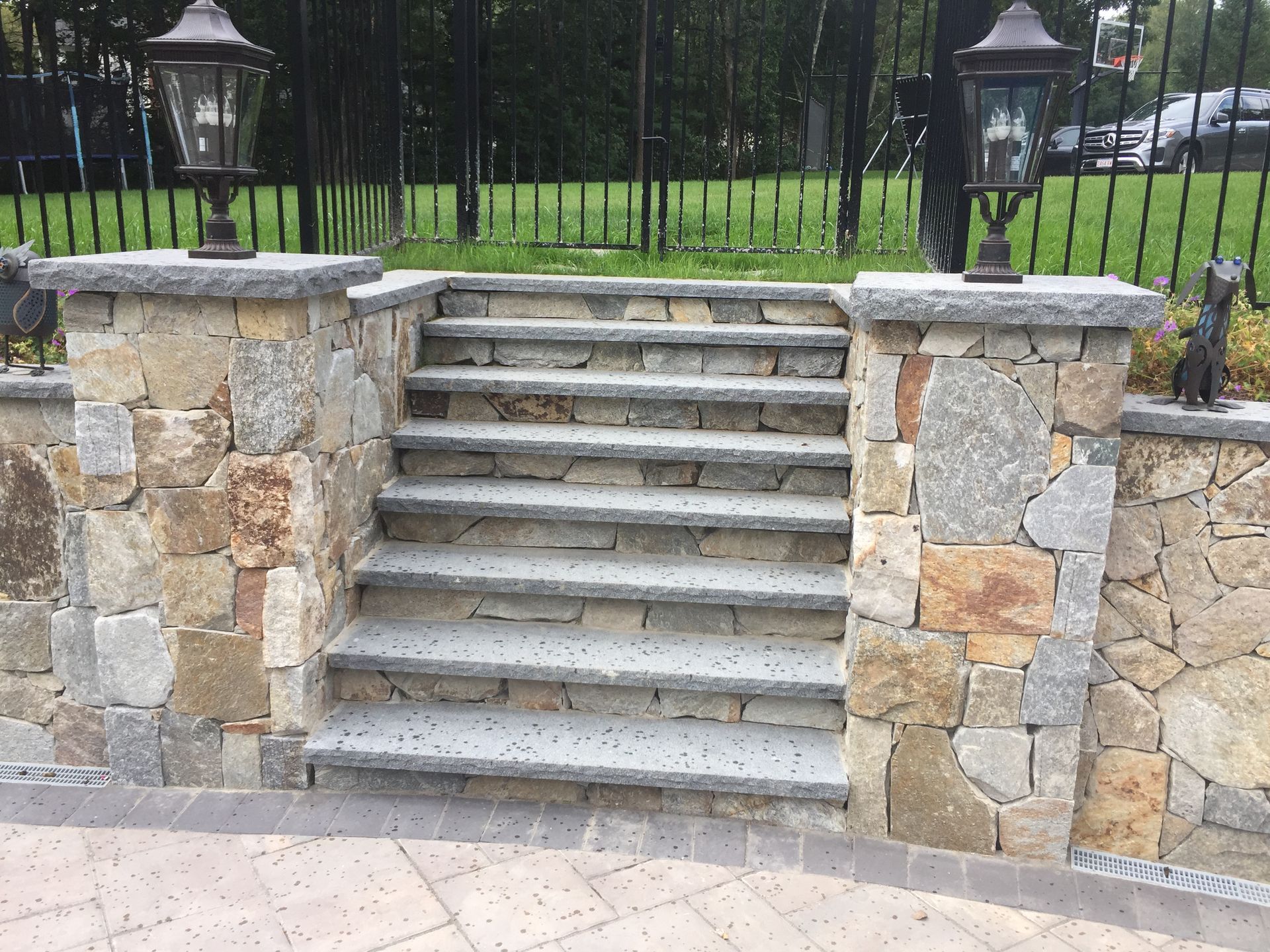 A set of stone stairs leading up to a stone wall