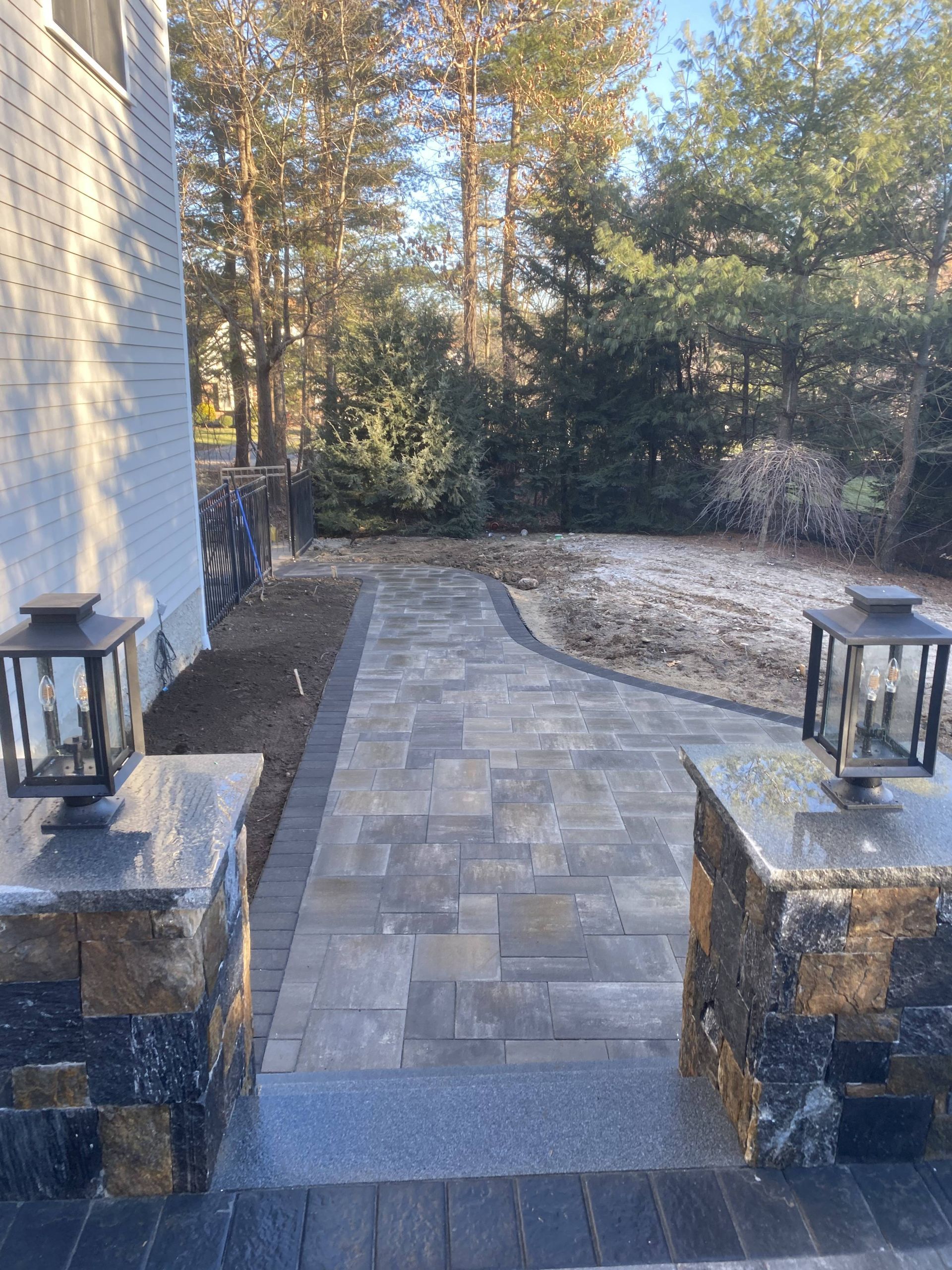 There are two lanterns on the side of the walkway.