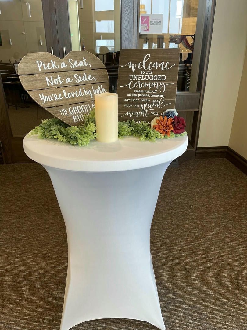 A table with a sign on it that says pick a seat not a suite