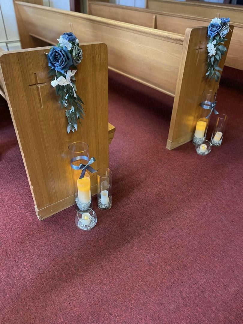 A church with candles and flowers on the benches
