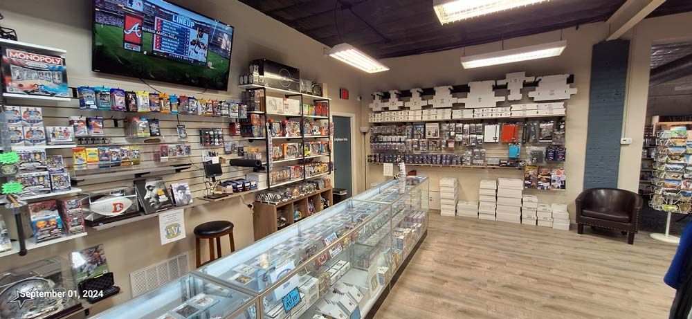 A video game store with lots of shelves and display cases.