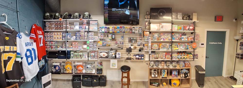 A room with a lot of shelves and a television on the wall.