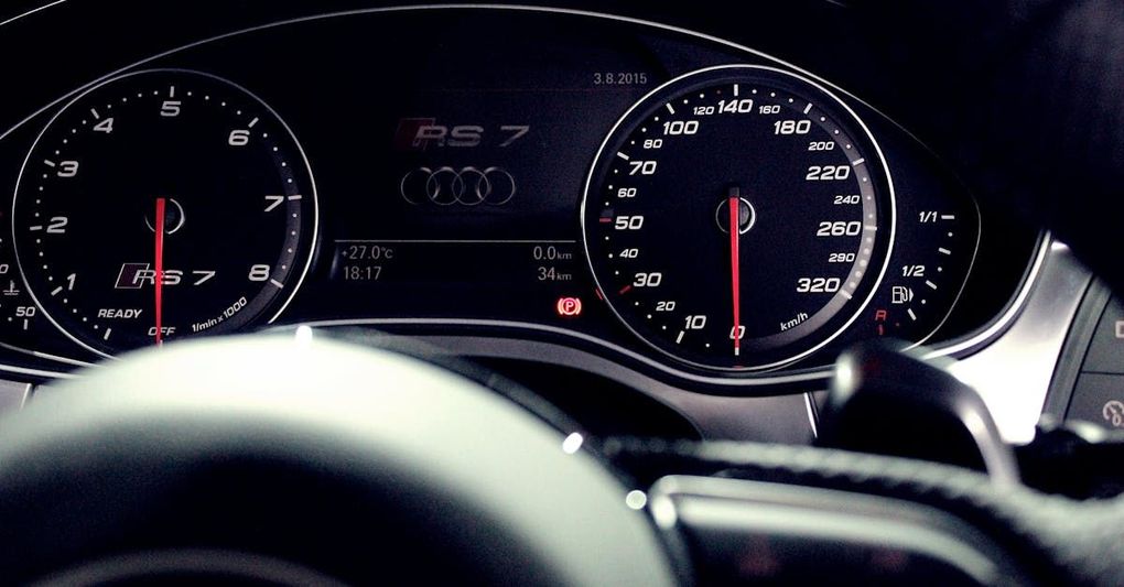 A close up of a car 's dashboard and steering wheel