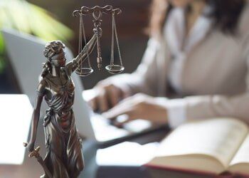 Statue of Justice And Lawyer Working On A Laptop — Estate Planing In Youngstown, OH