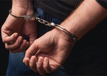 Young Criminal Stranding in Handcuffs — Criminal Defense Attorney Youngstown, OH