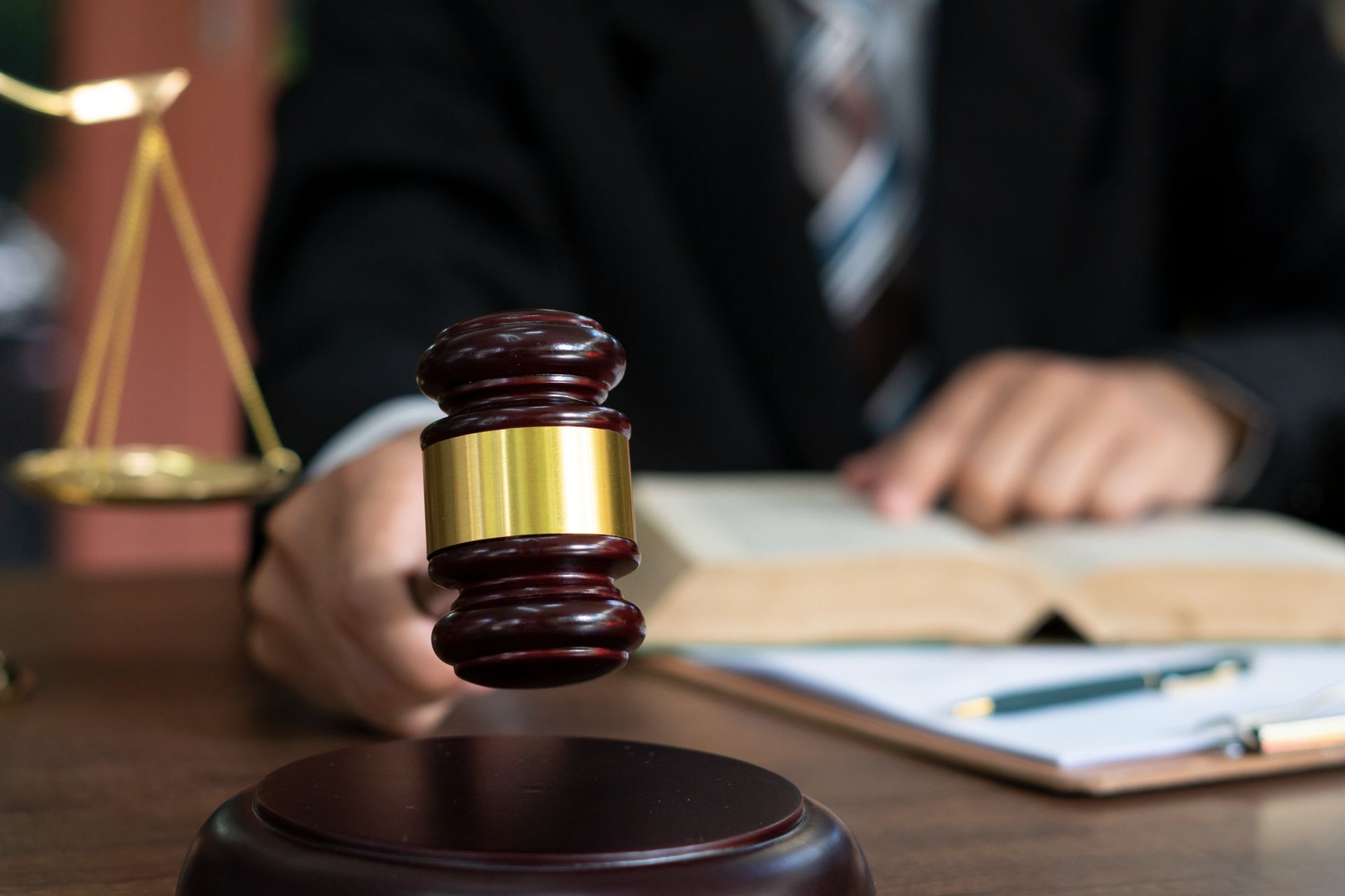 A criminal defense attorney with a gavel on a table.