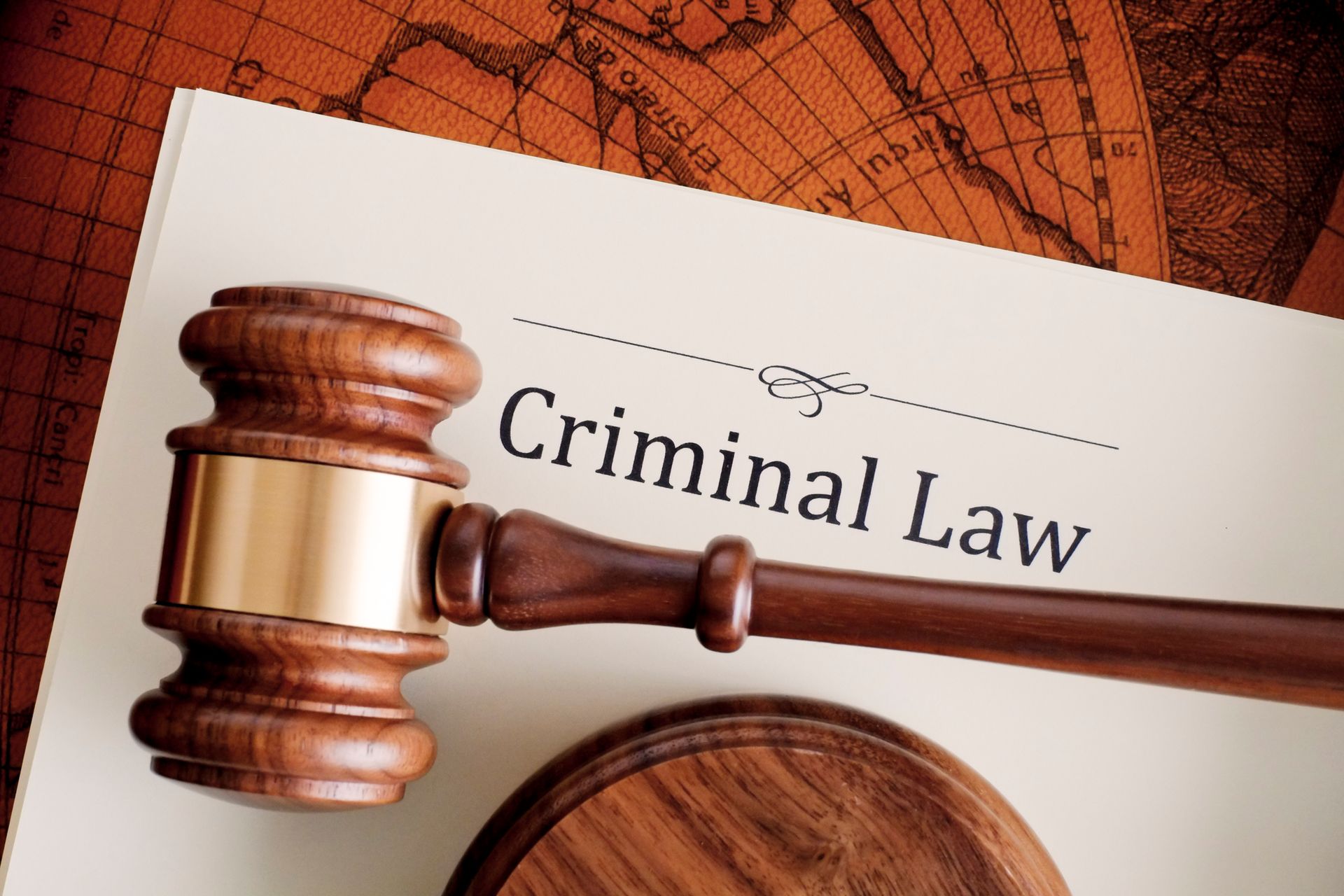 A paper reading criminal law with a gavel on top of it. In use by a criminal defense attorney.