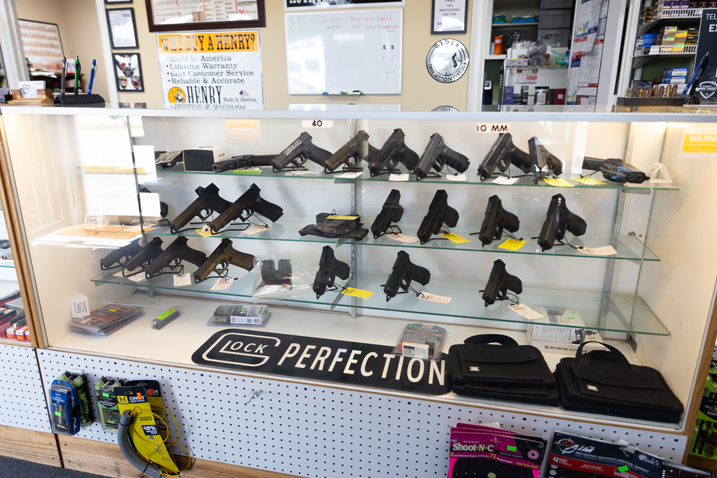 A shelf with rifles and shotguns available for purchase