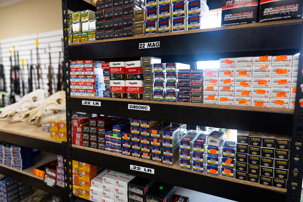 A shelf filled with boxes of ammunition in a store.