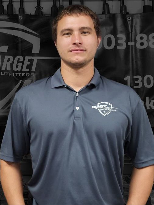 A man standing in front of a sign that says target