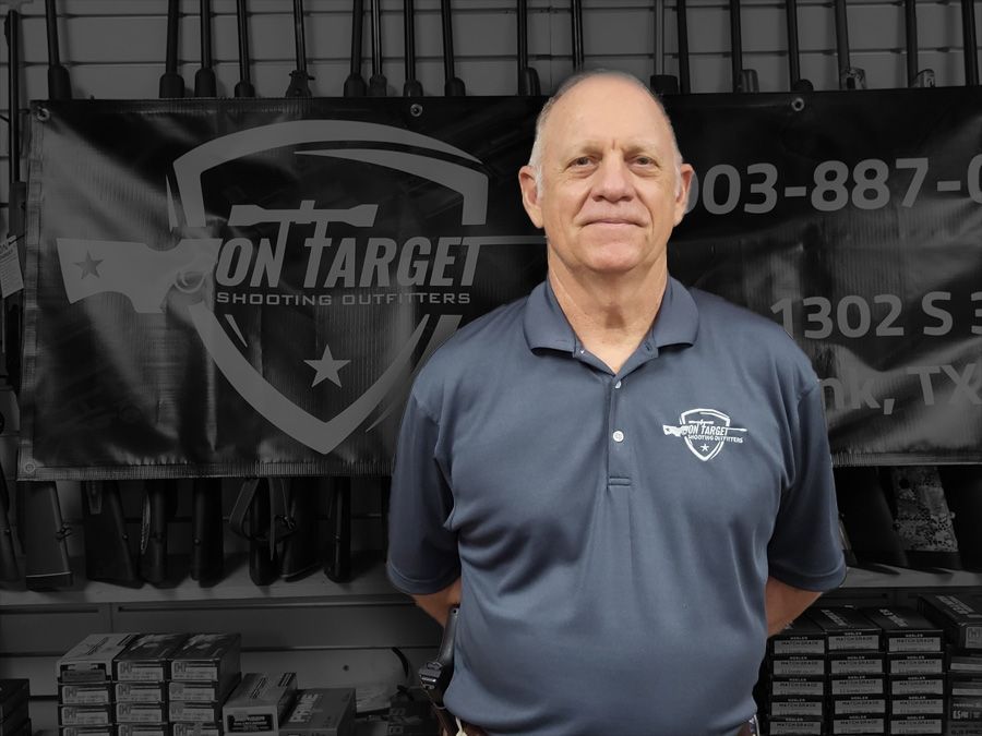 A man standing in front of a sign that says on target