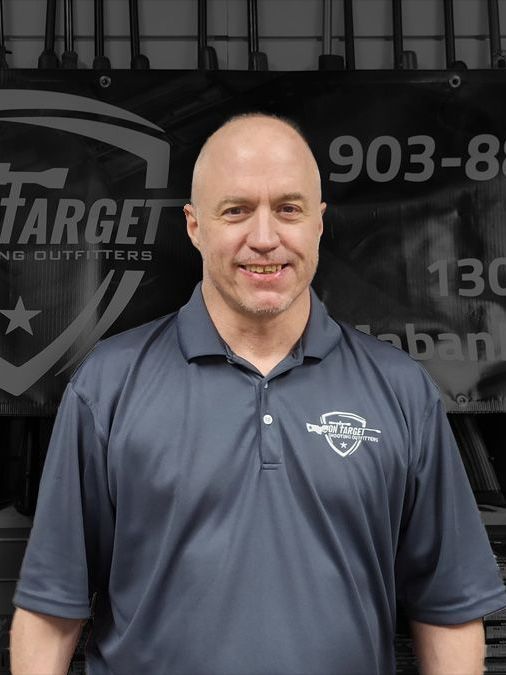 A man standing in front of a target sign