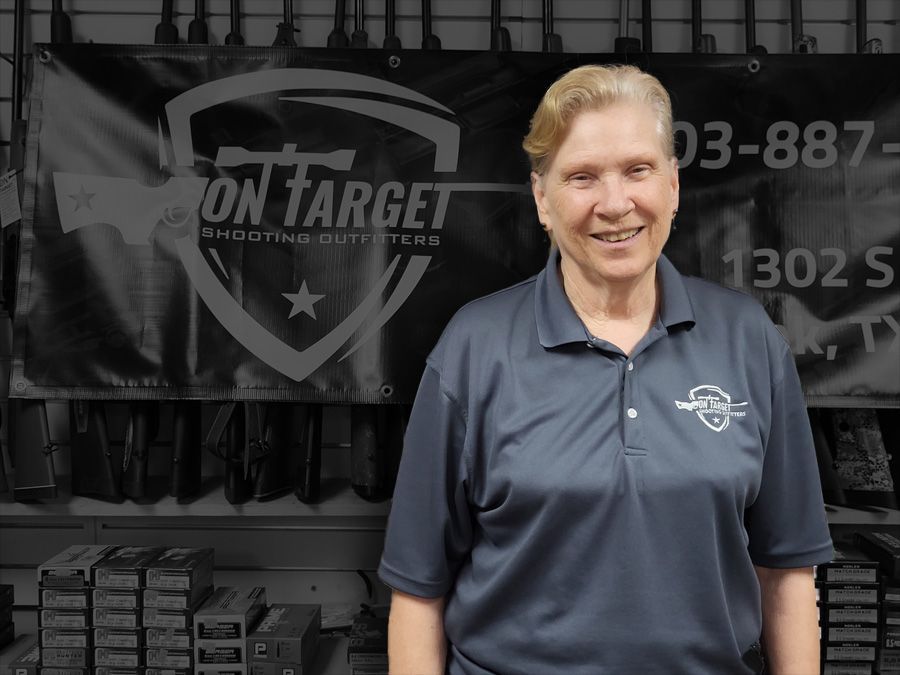 A woman stands in front of a sign that says on target
