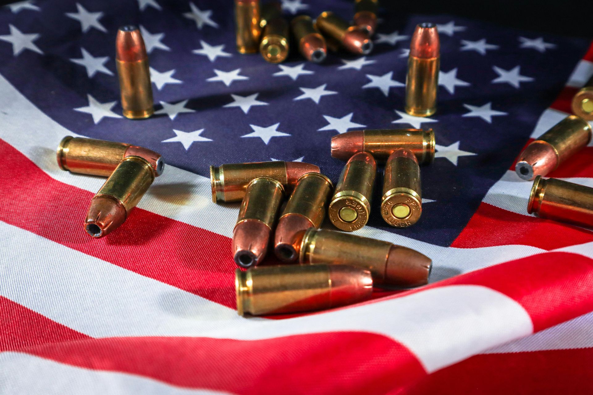 an american flag with pistol ammo laying on it