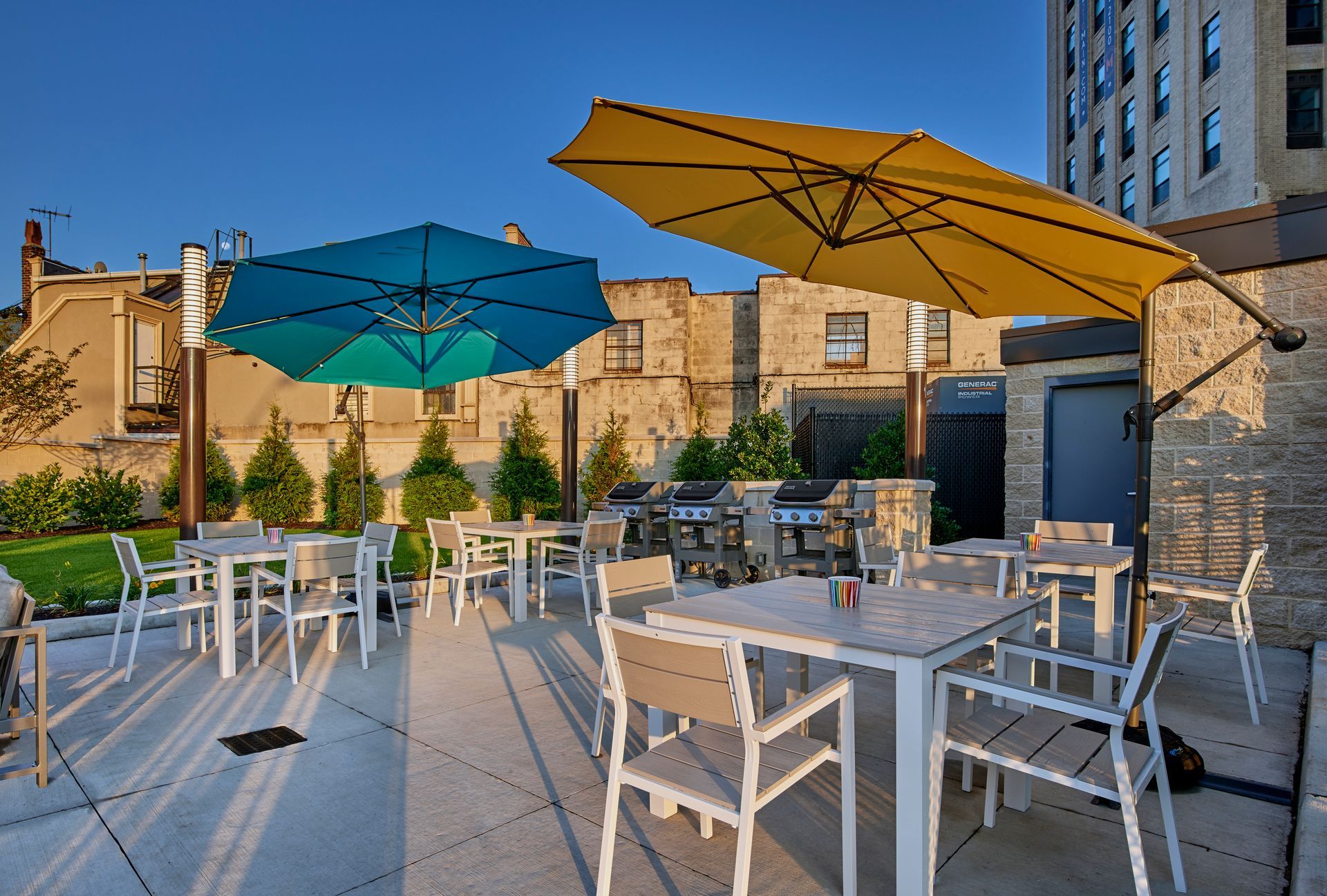 A patio area with tables and chairs and umbrellas