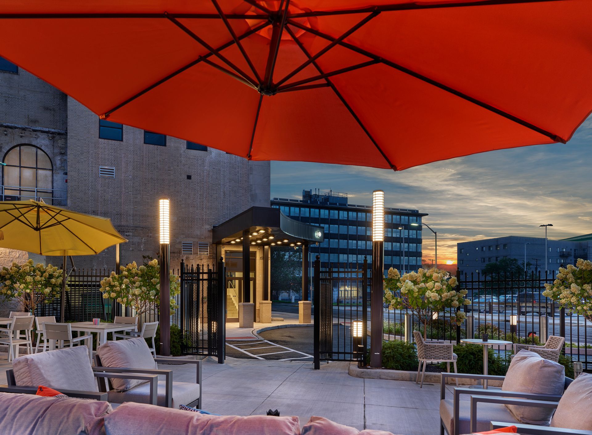 A large red umbrella is sitting on top of a patio