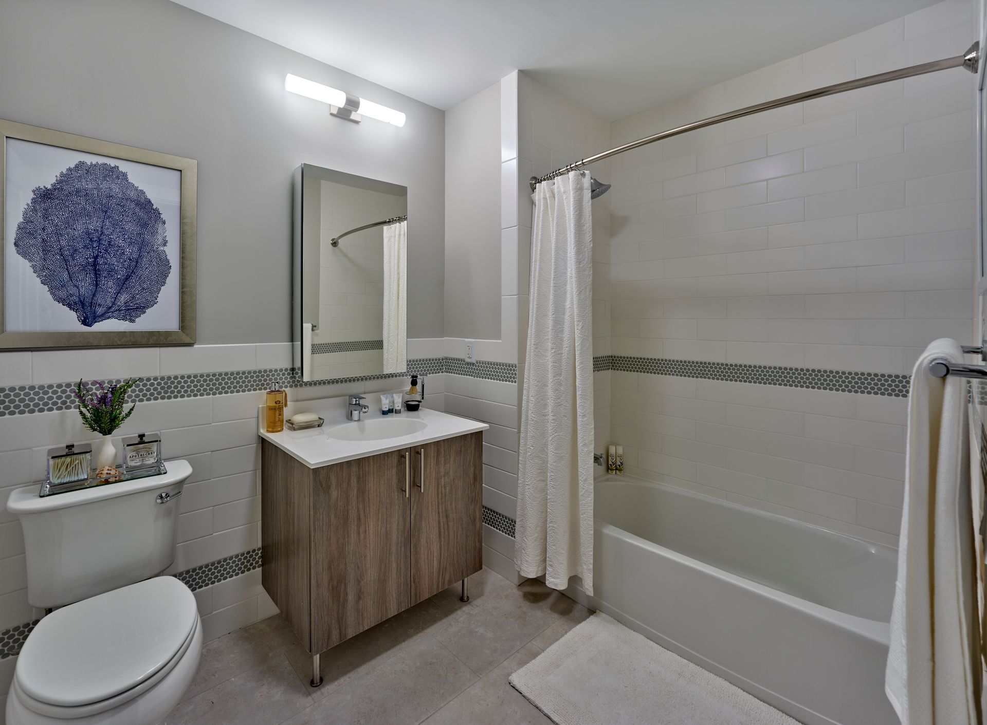 A bathroom with a toilet , sink , and bathtub.