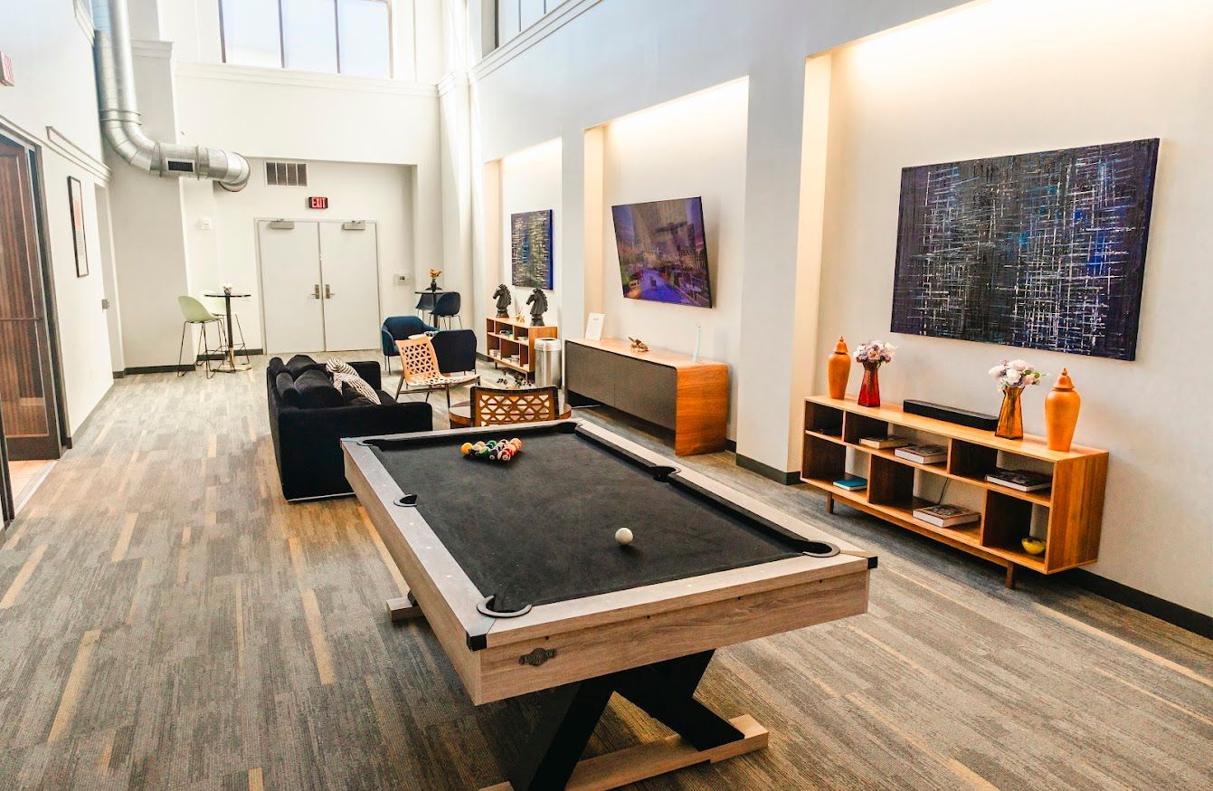 There is a pool table in the middle of the room.