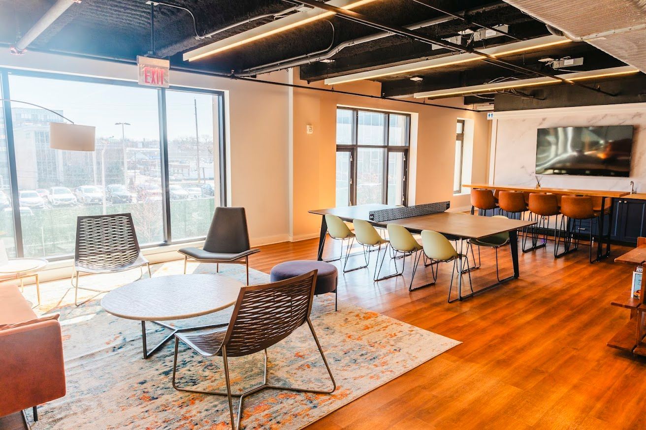 A large room with a table and chairs in it.