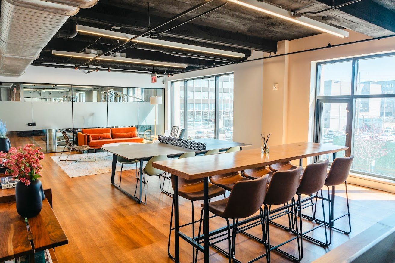 A large room with a long table and chairs in it.