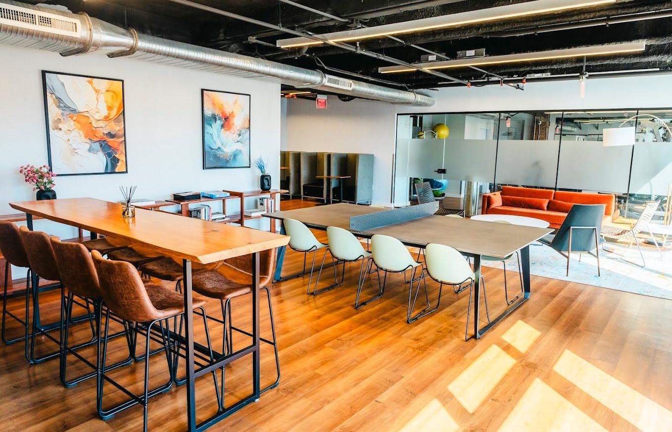 A large room with a long table and chairs in it.