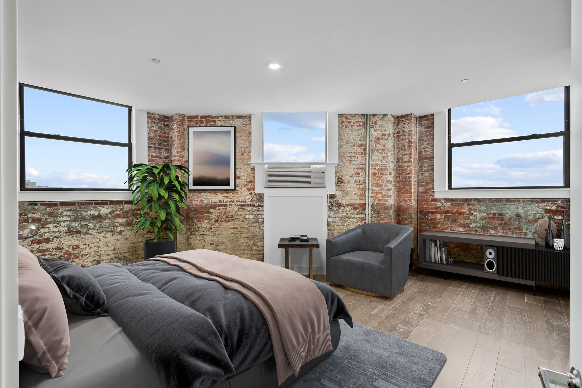 A bedroom with a bed , chair , and fireplace.