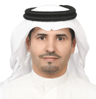 Man in traditional white Arabian attire, smiling at the camera.