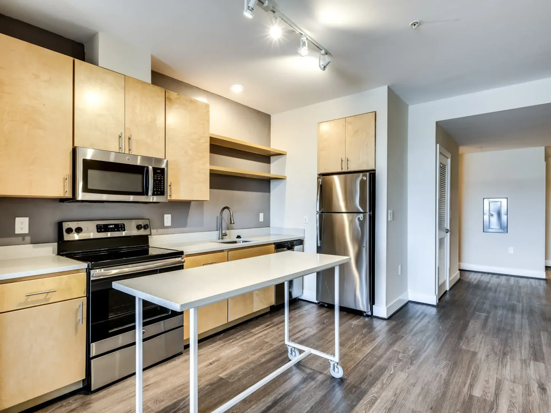 Highland Haus apartment modern kitchen with light brown cabinets and spacious island.