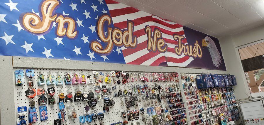 Different Keychains Below In God We Trust Banner - Clovis, CA - A1 Lock and Key Services