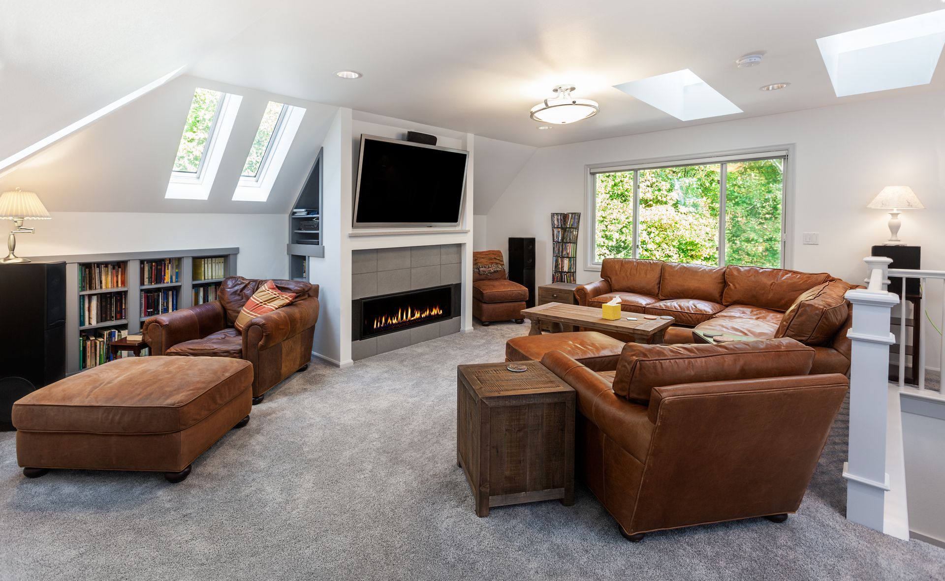 Skylights without Hunter Douglas Roman shades in a cozy media room with large leather couches 