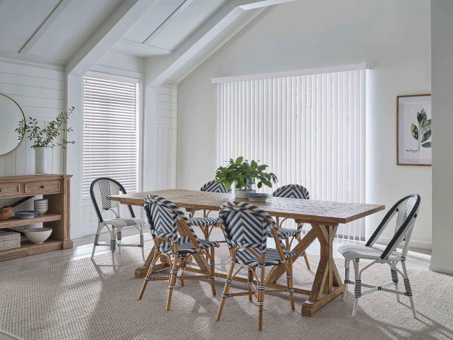 Dining room with wooden table, patterned chairs, and white walls.