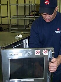 Man Inspecting Oven — Convection Ovens in Providence, RI