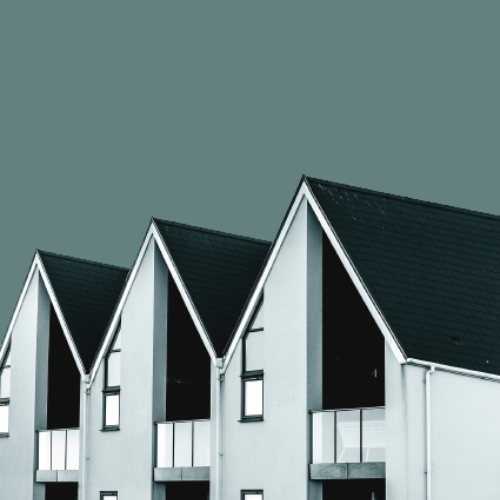 a row of white houses with black roofs