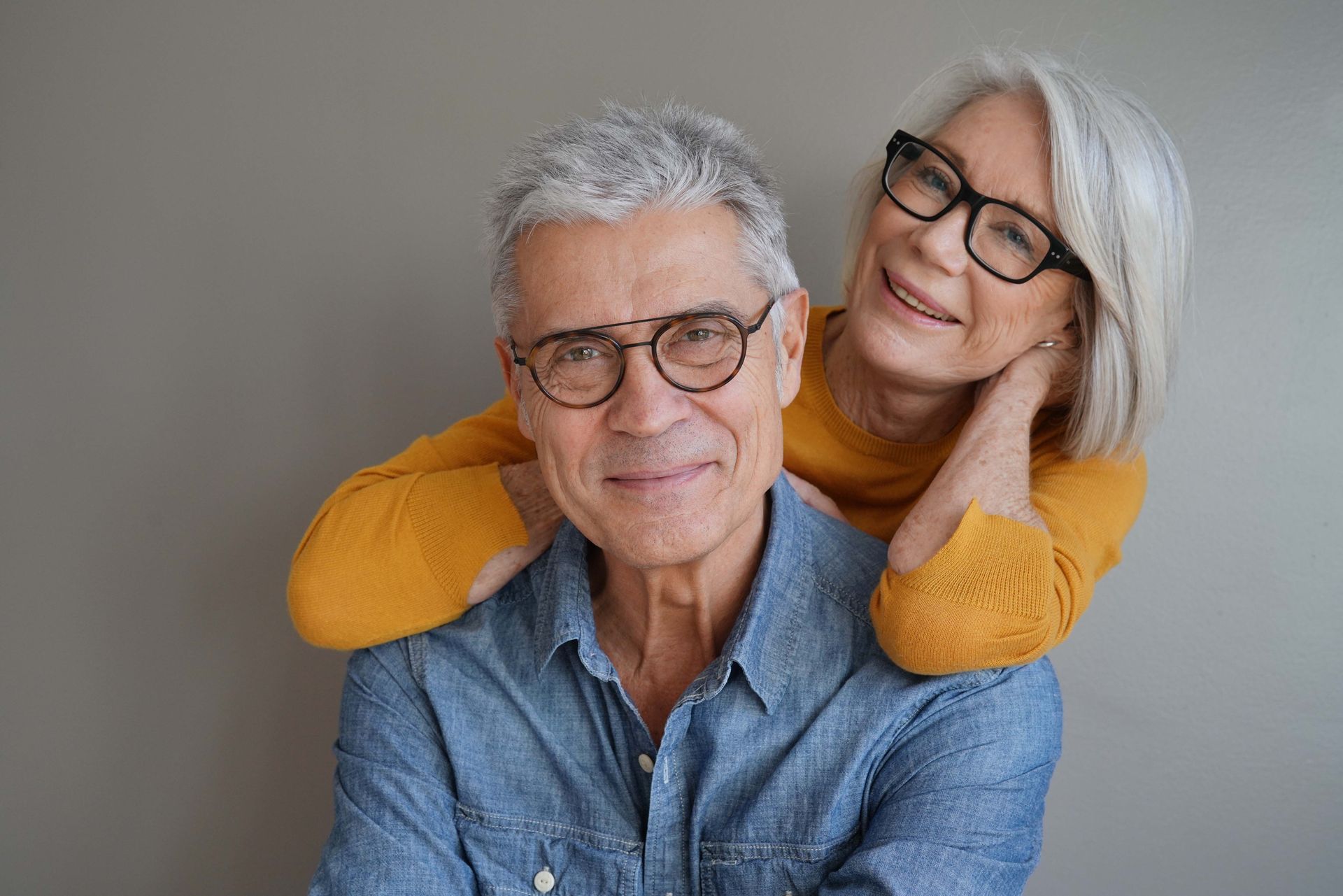 a man and woman wearing glasses are posing for a picture