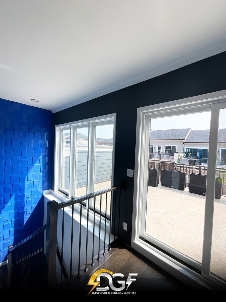 A room with a lot of windows and a blue wall