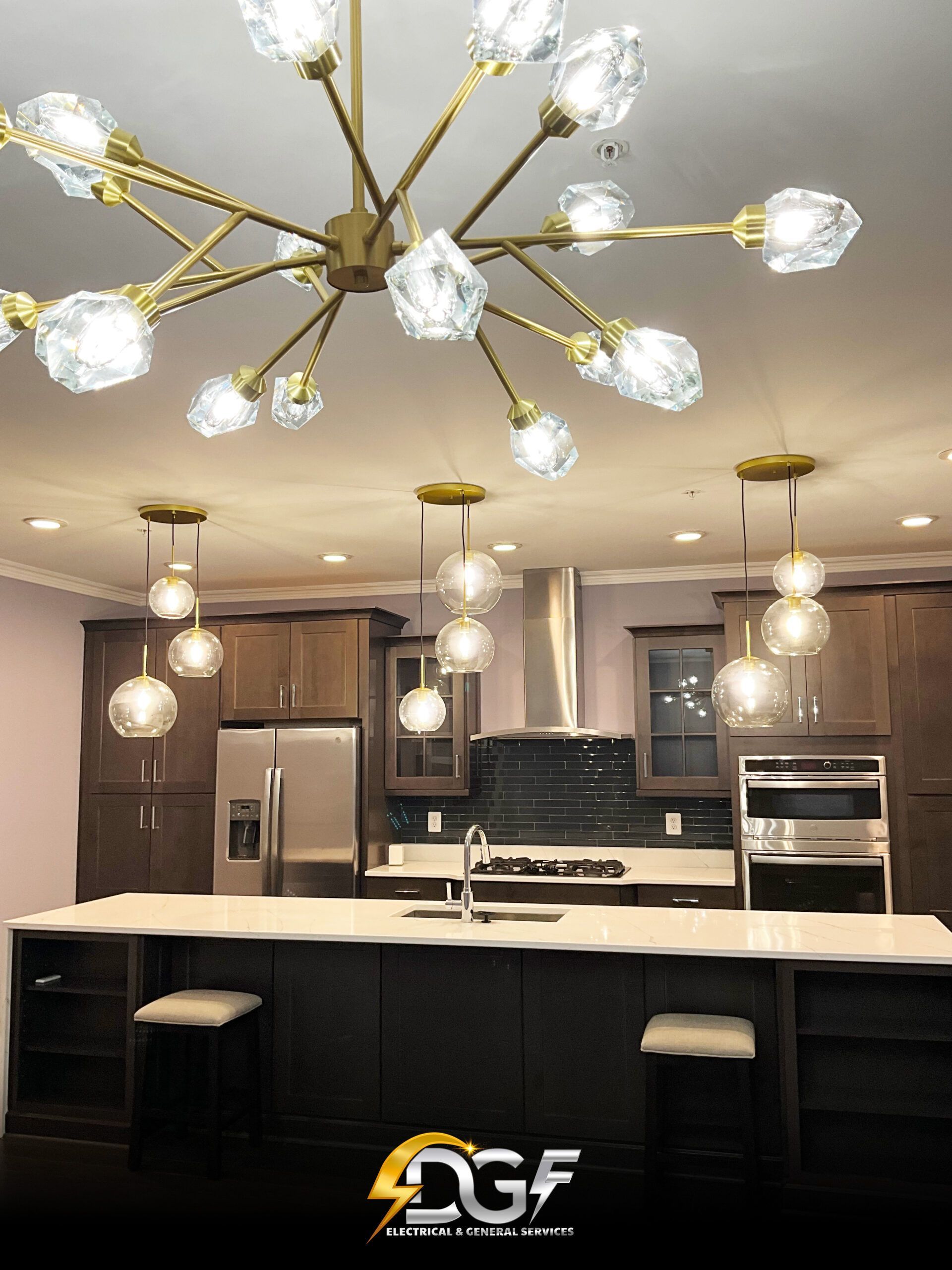 A kitchen with a large island and a chandelier hanging from the ceiling