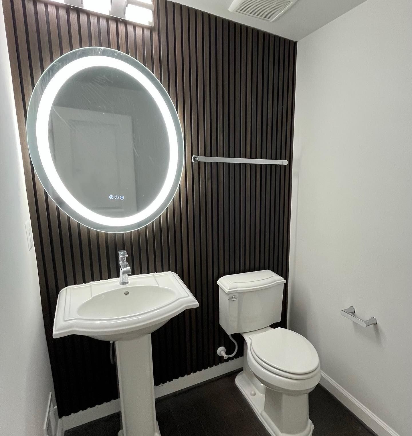 A bathroom with a toilet , sink and mirror