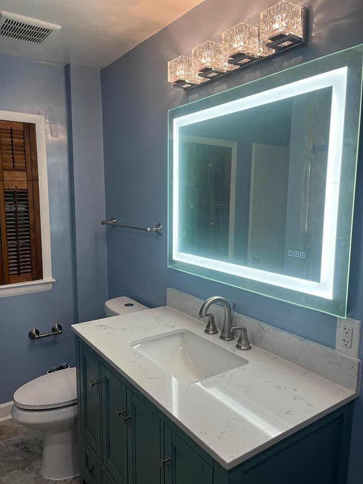 A bathroom with a sink , toilet , and mirror.